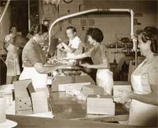 A group of people in a room with boxes.