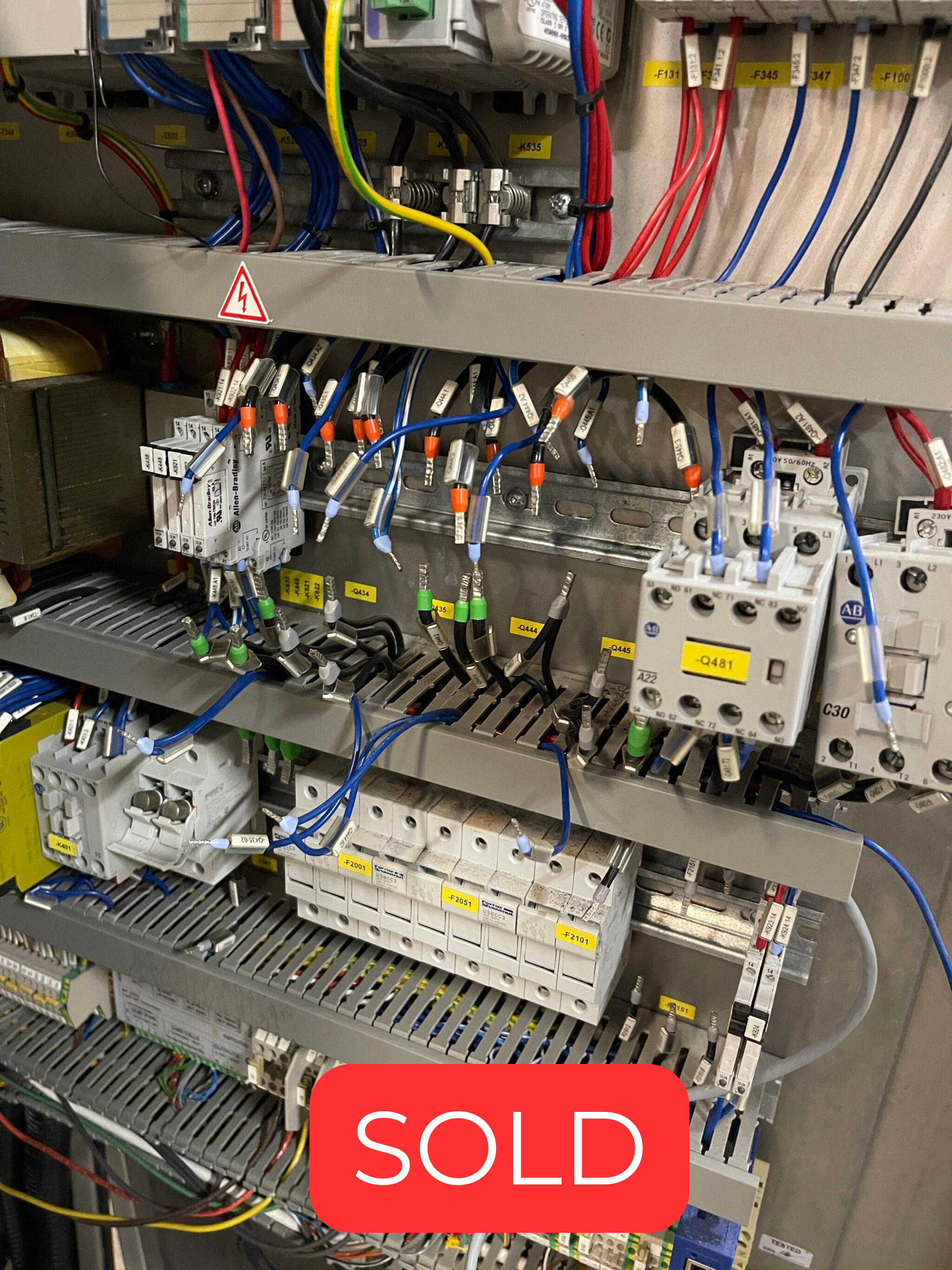 Industrial electrical control panel with many colored wires, terminals, and relays; a 'SOLD' badge overlays the image.